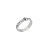 side view of a silver ring featuring a small skull at the front, with a pattern of circular indentations around the band.